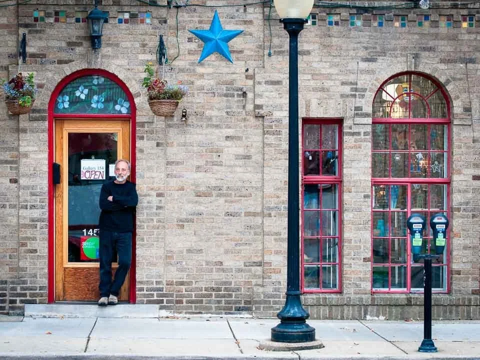 [9/100] Ron - I walk past this store frequently and have on several occasions seen Ron standing in the doorway and said hello as I passed. I've always liked the "feel" of the store exterior - the bright red trim, arched doorways, etc. and with Ron le