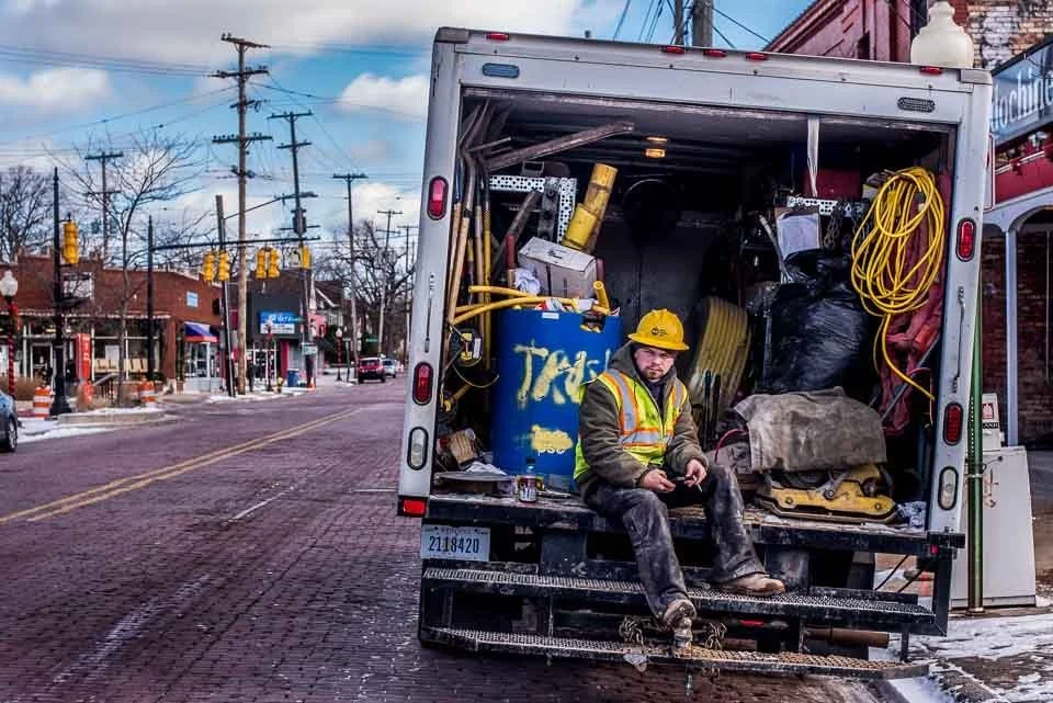 [31/100] Mike - I was walking near my home and came across Mike sitting on the bumper of this truck, taking a break from construction work. His pose and the context of the truck caught my eye. I introduced myself to Mike, briefly explained the projec