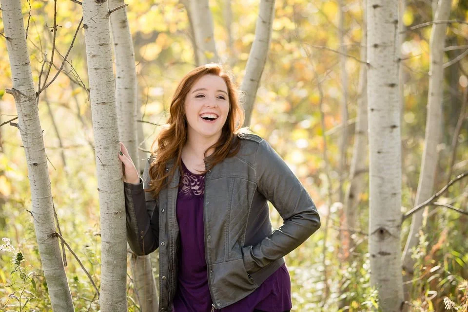Early fall senior portraits in West Michigan among birch trees with golden foliage