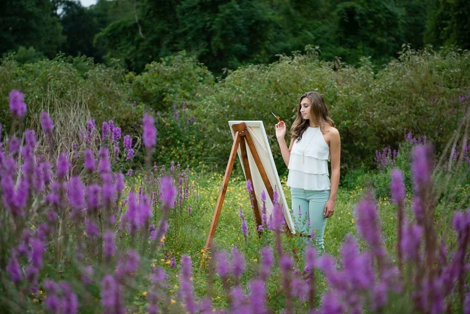 senior-girl-paints-in-field-of-flowers-near-grand-rapids.jpg