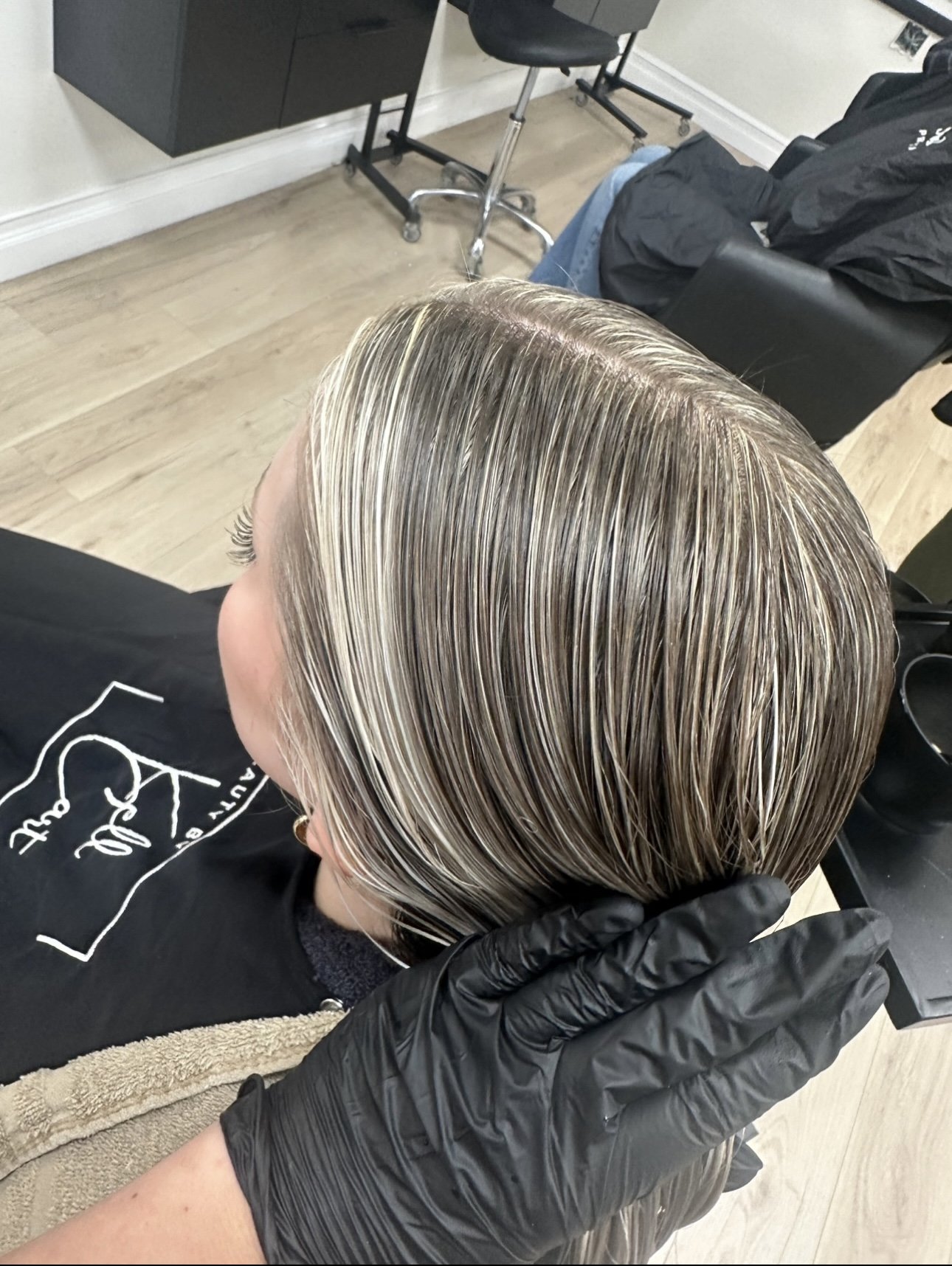 Client receiving a luxury hair color service at Beauty By Kell Cart in Saint James, NY.