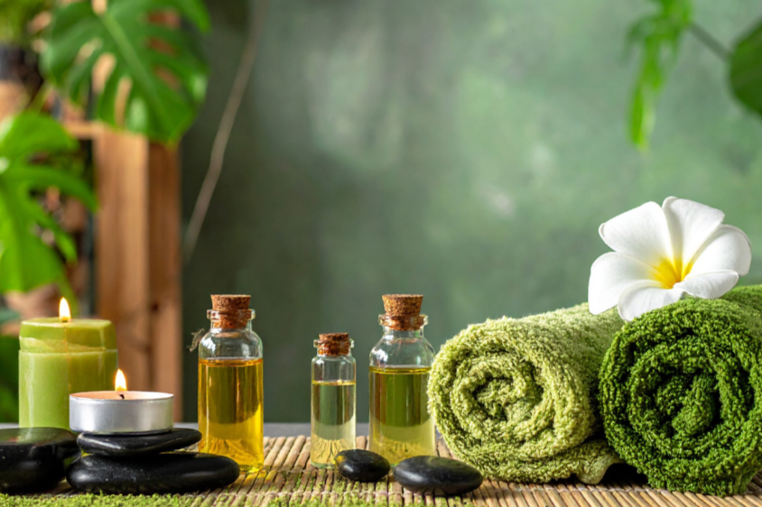 A spa setting with towels and plants for Massage Therapy and Structural Integration used to restore balance, relieve tension, and support the body’s natural alignment at Wellness Restoration in Jackson, MS