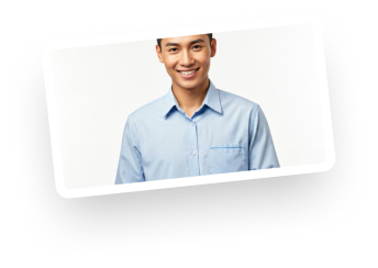 A smiling young man in a light blue button-up shirt, posing against a plain white background.