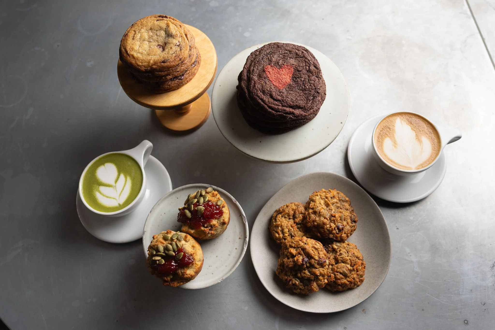 Clockwise from left: matcha latte, chocolate chip cookies, chocolate espresso cookies, latte, carrot cake cookies and high-protein banana muffins
