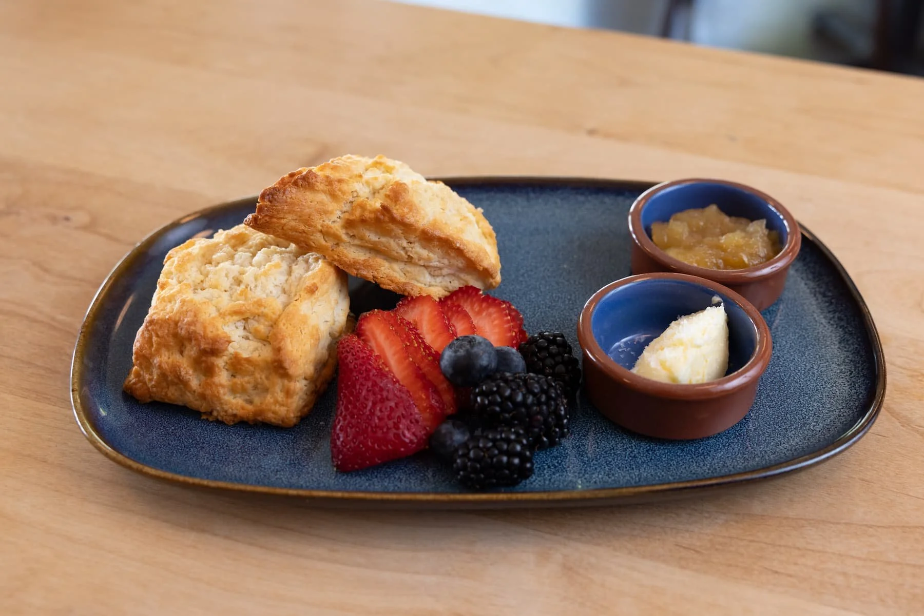 Two plain, gluten-free scones, house jam, seasonal fruit, honey butter