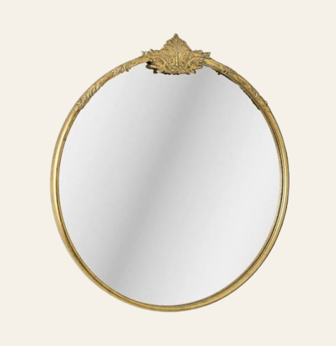 An ornate vintage oval mirror with a gold decorative frame against a cream background.