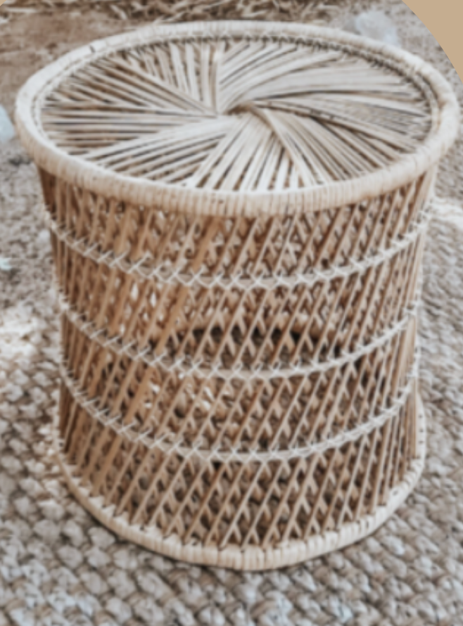 Three round woven rattan or wicker baskets stacked on a plush, beige carpet.
