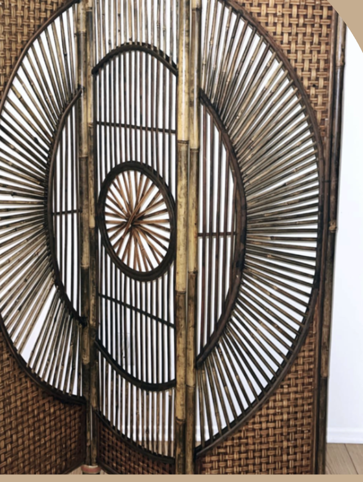 Decorative bamboo and rattan room divider with circular design patterns.
