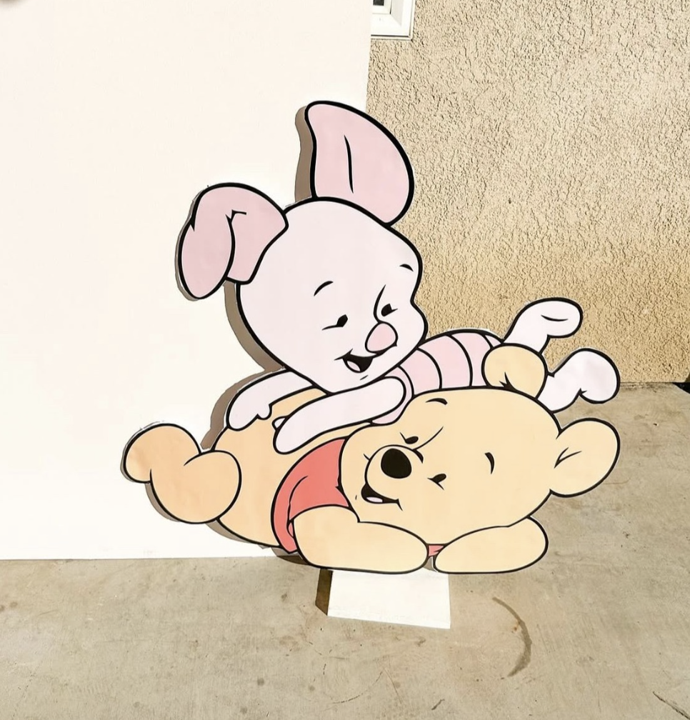 Cartoon of a rabbit and a bear playing with each other, with the rabbit on top of the bear, both smiling.