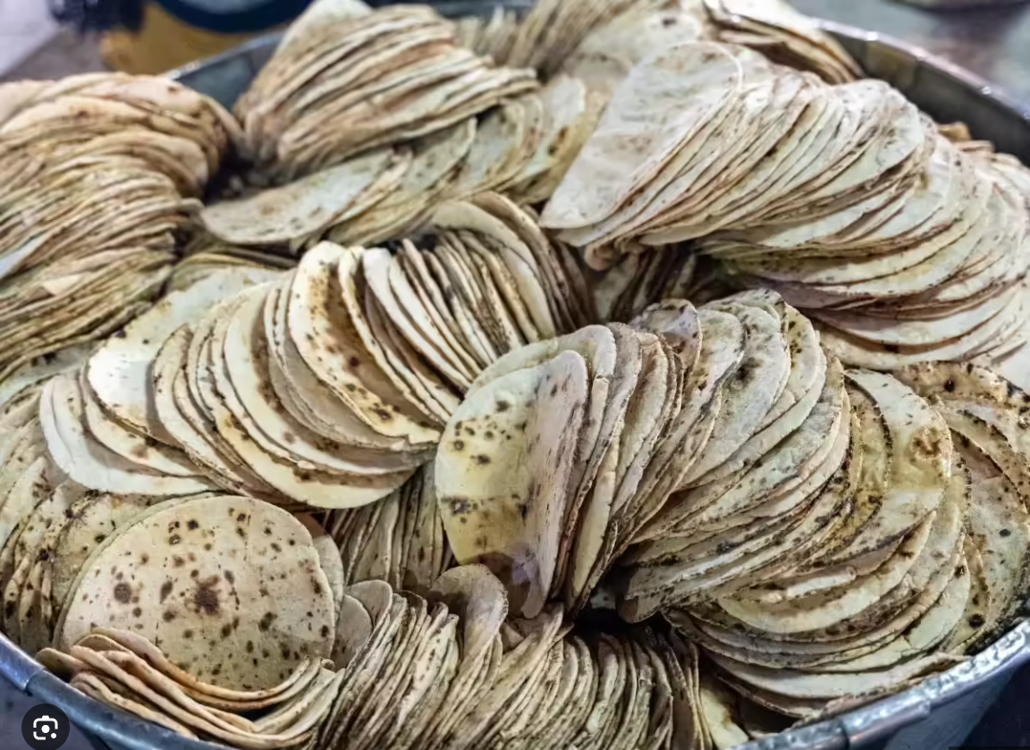 "Volunteers of all backgrounds preparing shared meal Roti Prasad at Guruji Sangat Seattle"