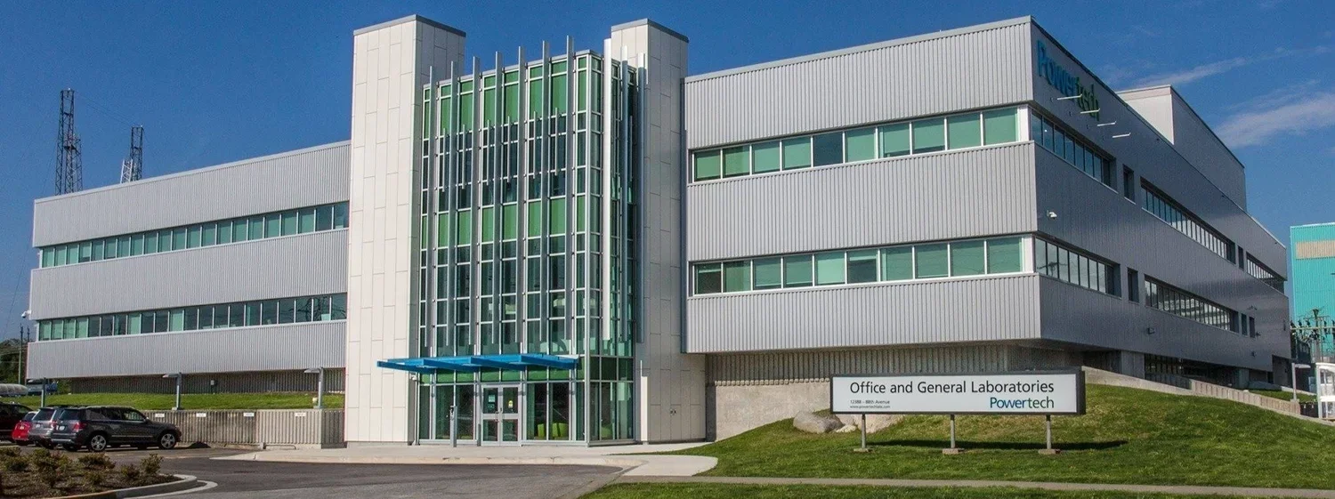 Modern office building with a sign indicating it houses office and general laboratories for Powertech.