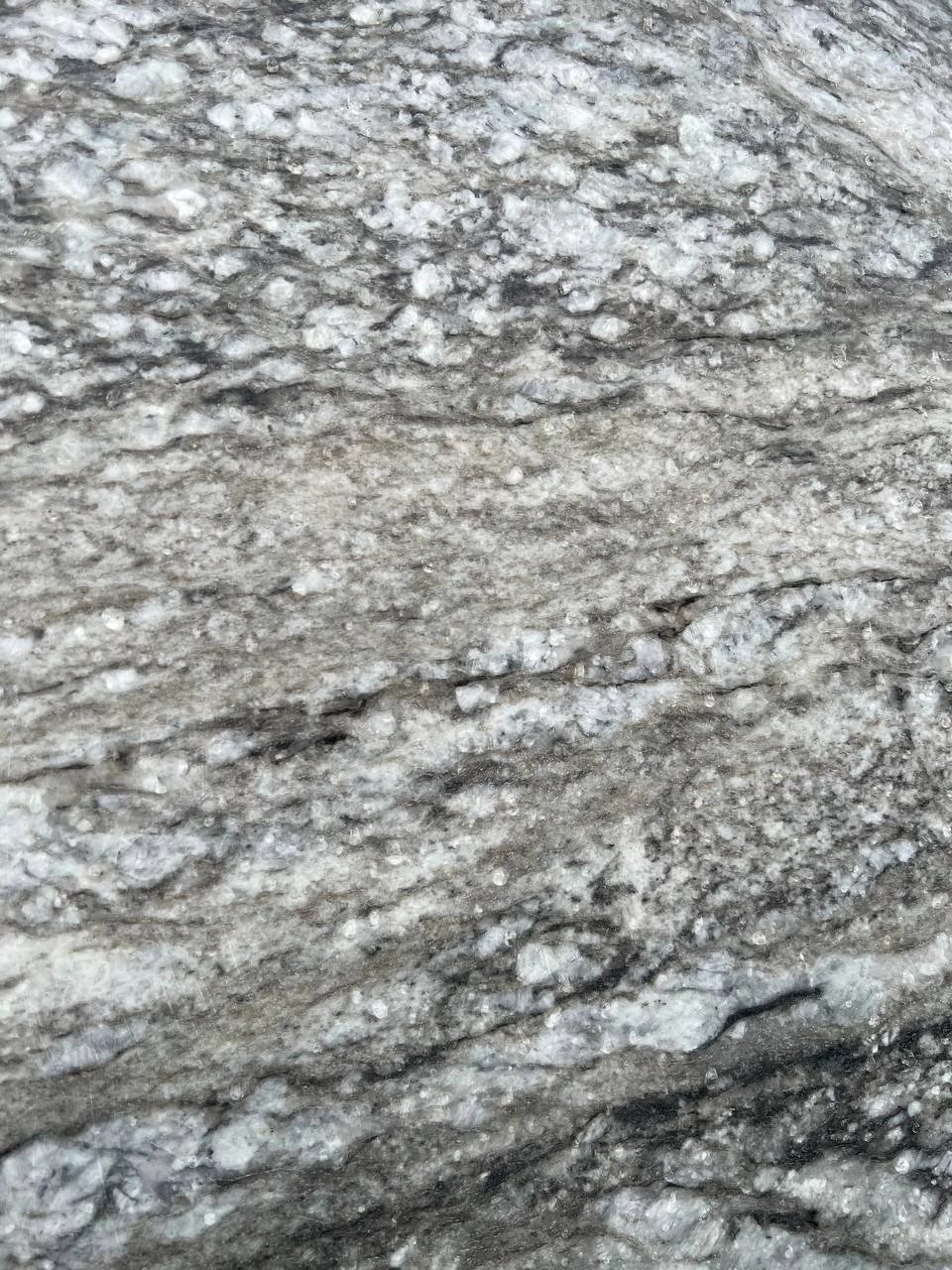 Thunder White Granite. Close-up of a granite surface with gray and white patterns.
