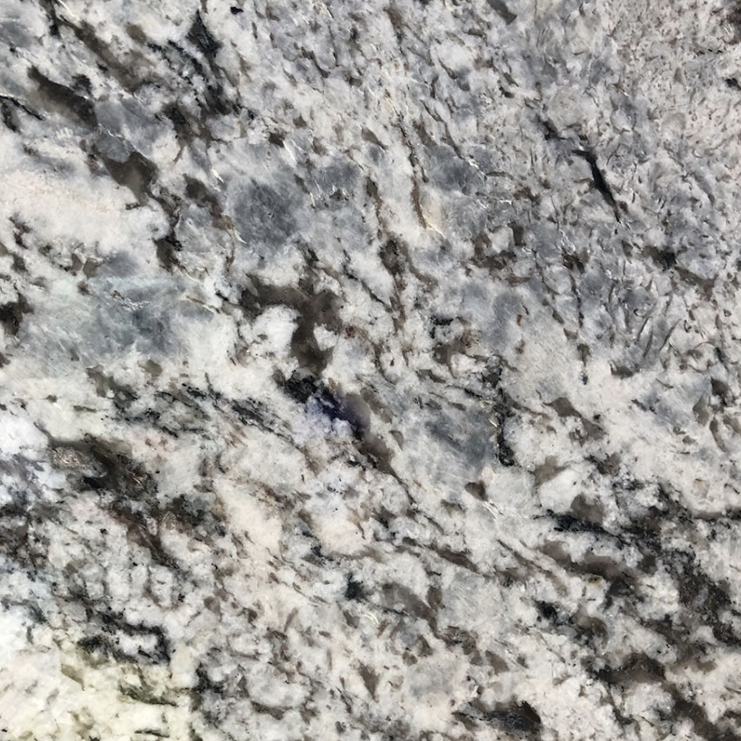 Lennon Granite. A Close-up of a granite surface with gray, white, and black speckled patterns.