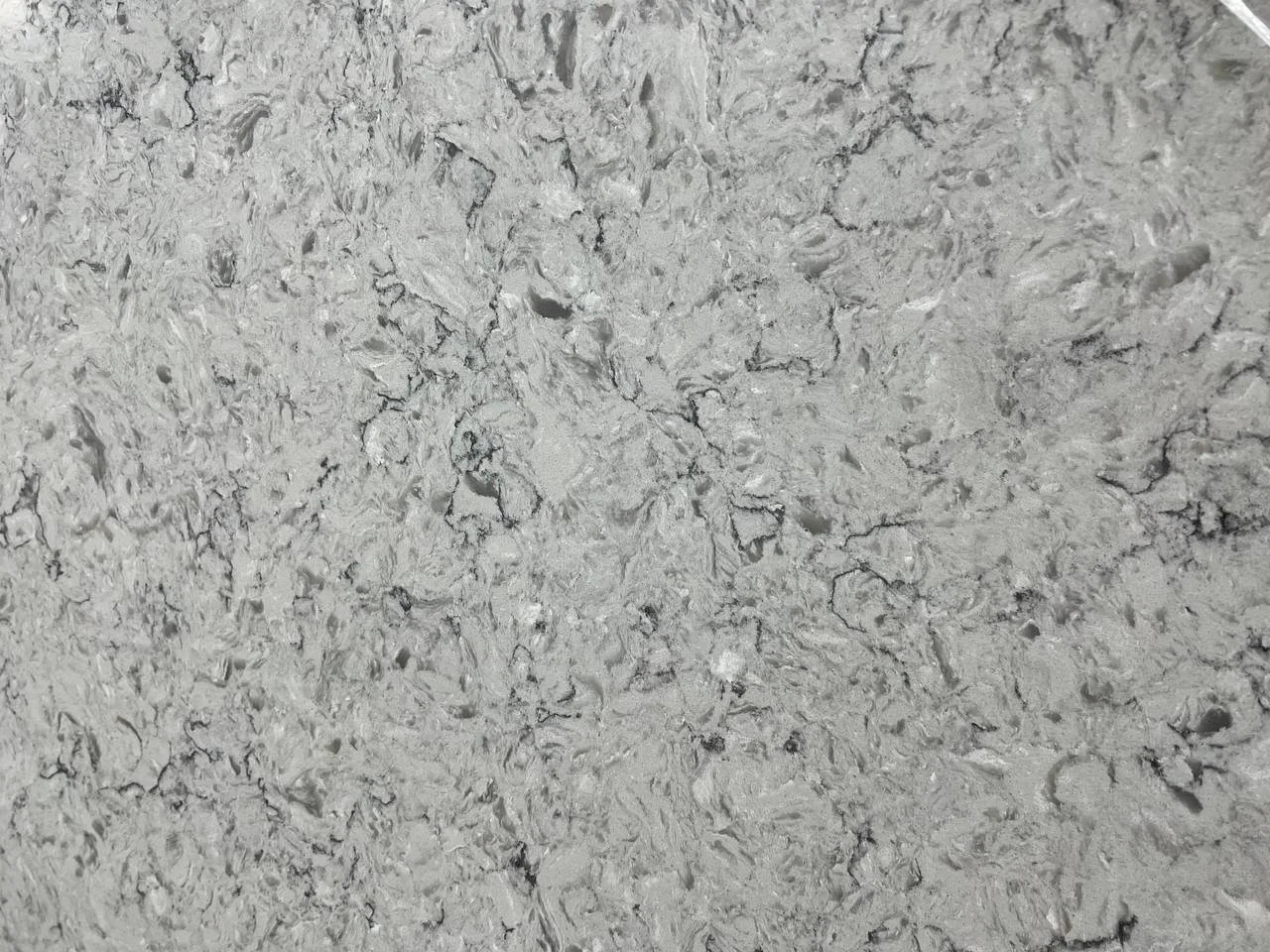 Alpine Winter Quartz. A Close-up of gray marble texture with intricate patterns and black veins