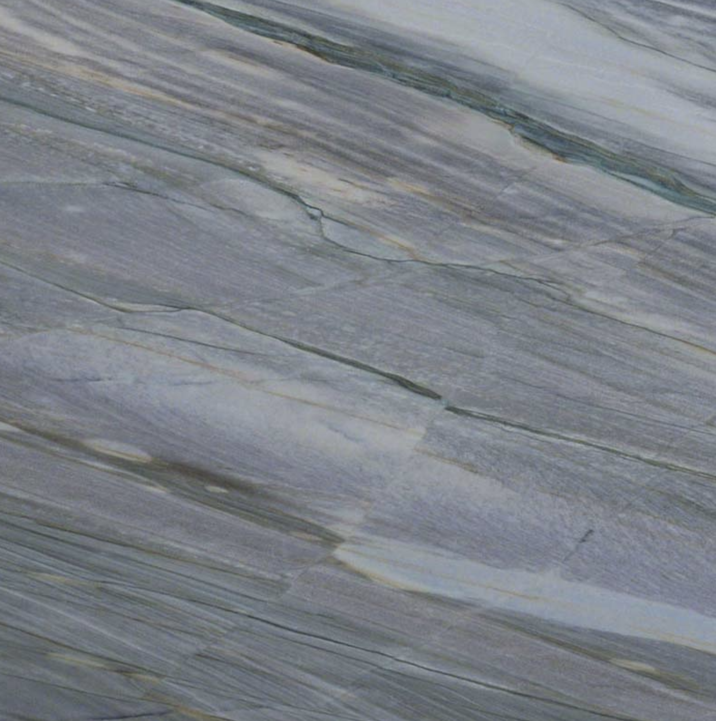Azul Imperial QUARTZITE. A Close-up of a textured blue and gray marble surface with streaks and veins.