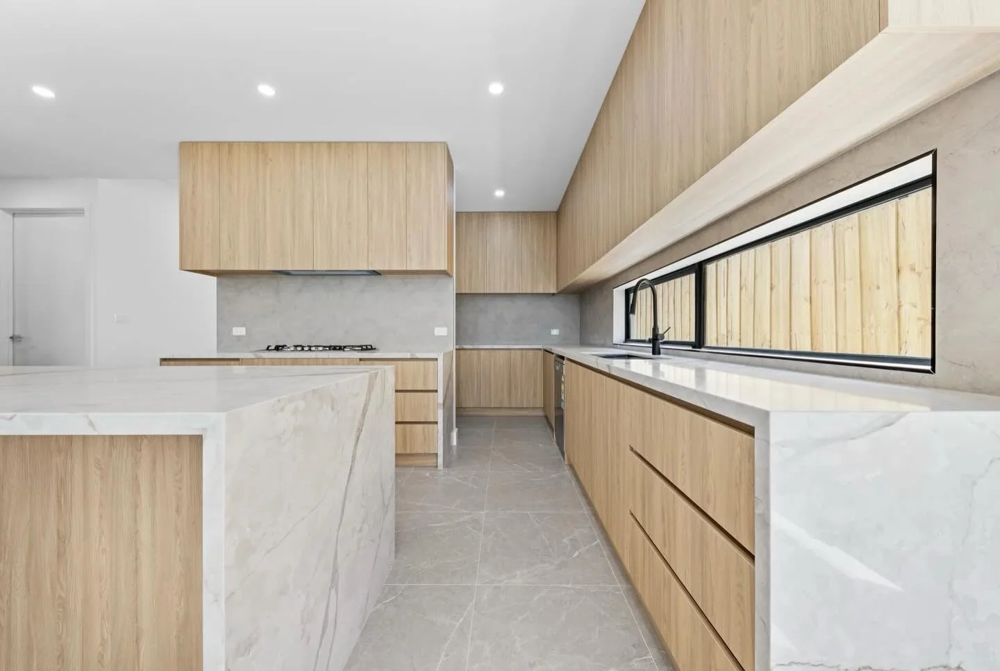 ✨ Minimalism, but make it warm. ✨

This stunning kitchen is where modern design meets everyday functionality, featuring sleek stone benchtops, warm timber cabinetry, and a layout made for entertaining.

From morning coffees to family dinners, this sp