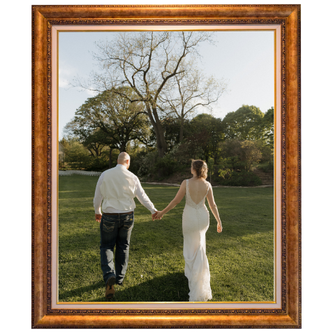 A couple holding hands and walking away in a park during daytime, with trees and grass in the background.