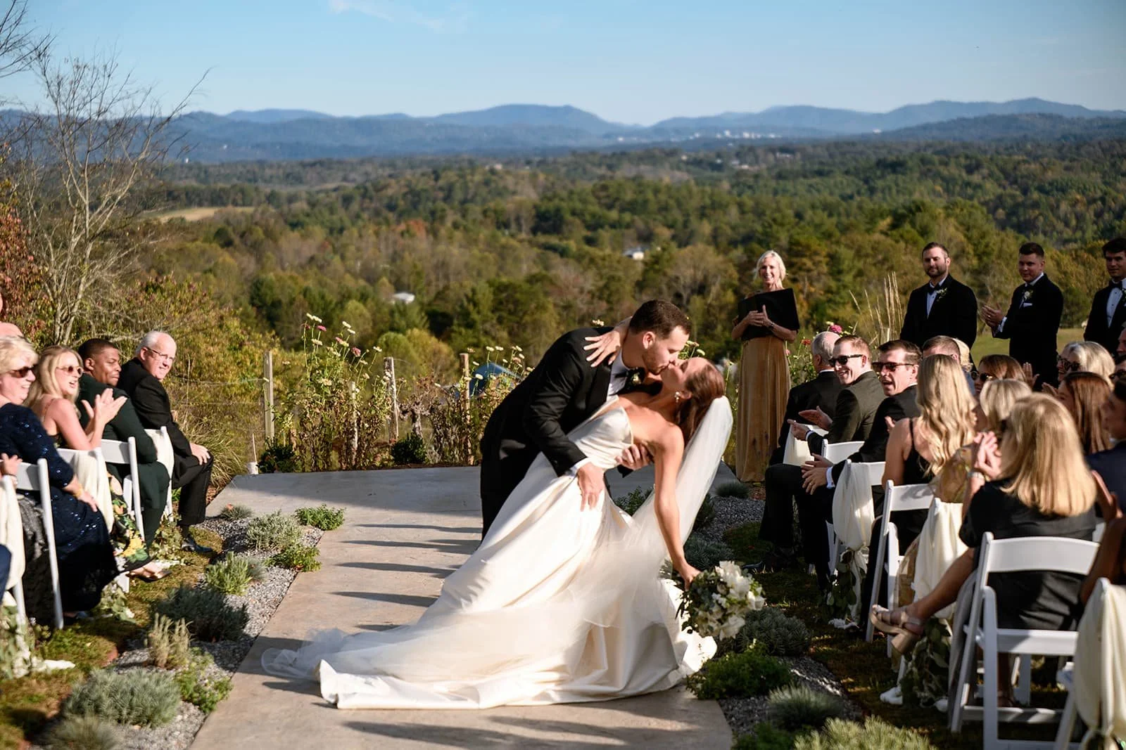 bride and groom dip photo at the end of the aisle