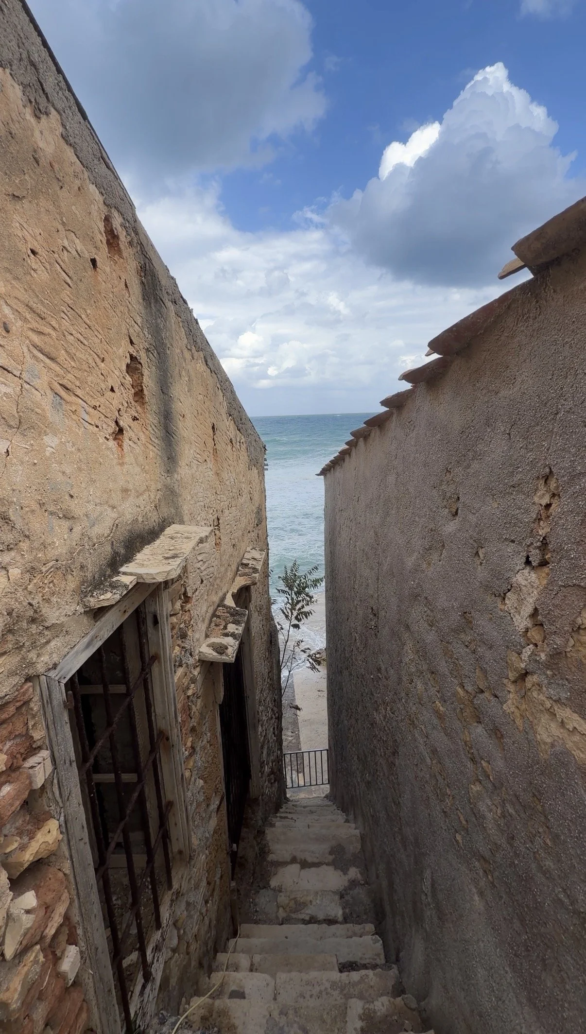 Narrow stone stairway leading down to the sea