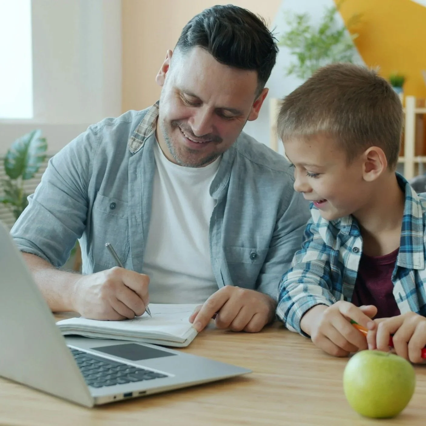 A man doing bookwork with a child.
