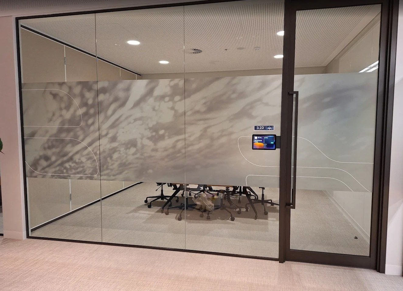 Decorative custom-printed frosted window film featuring a landscape design for office glass partitions.
