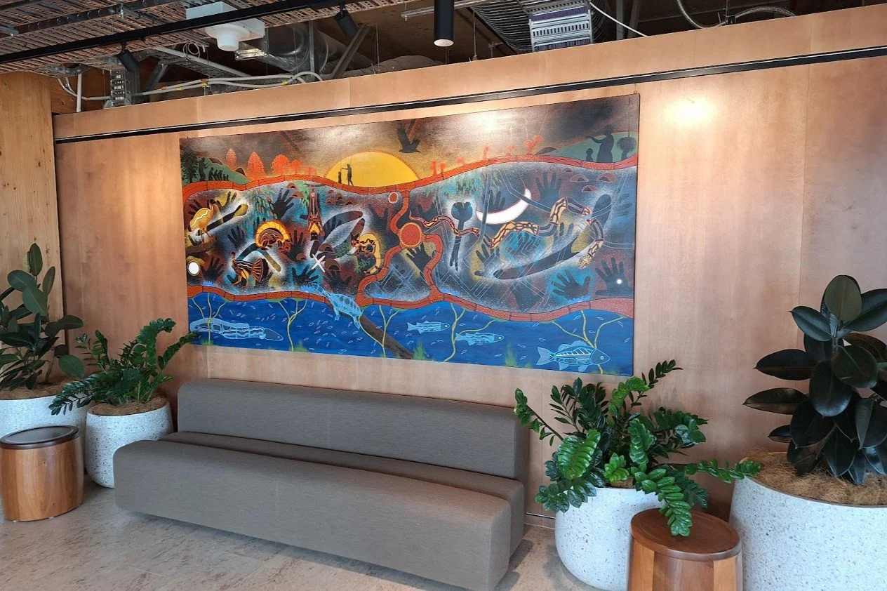 Large-scale stretched canvas mural installed using a professional gallery rail hanging system on a timber wall.