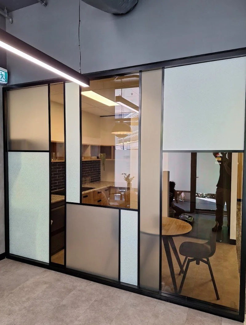 Frosted glass window film installation with custom decorative patterns for office meeting room privacy in Brisbane.