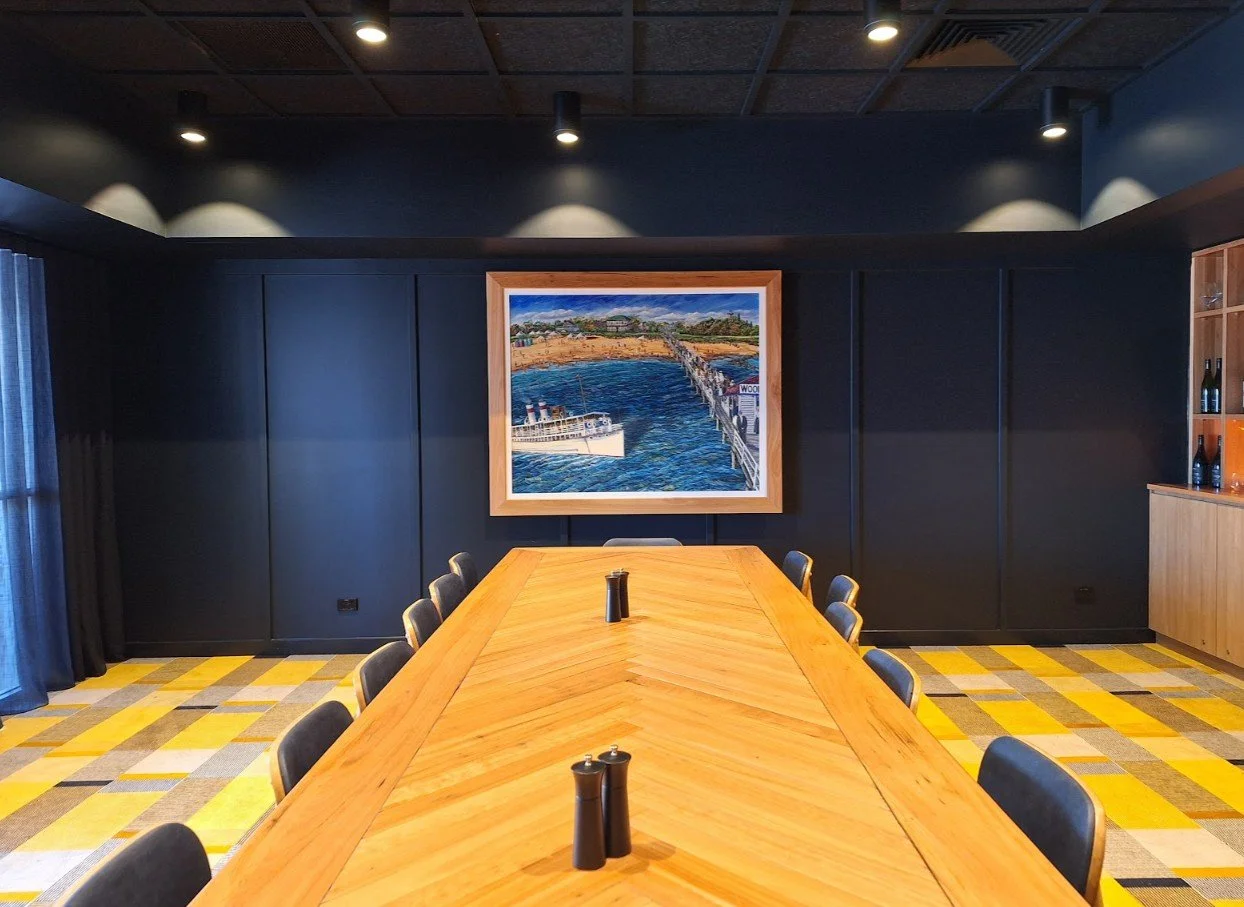 Large custom framed print professionally installed in a modern corporate boardroom in Brisbane.