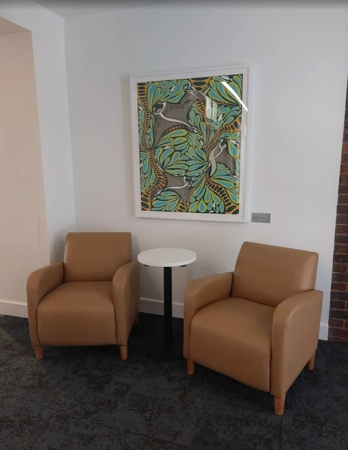 Modern colourful artwork in a professional gallery-style frame, installed in a corporate waiting area.
