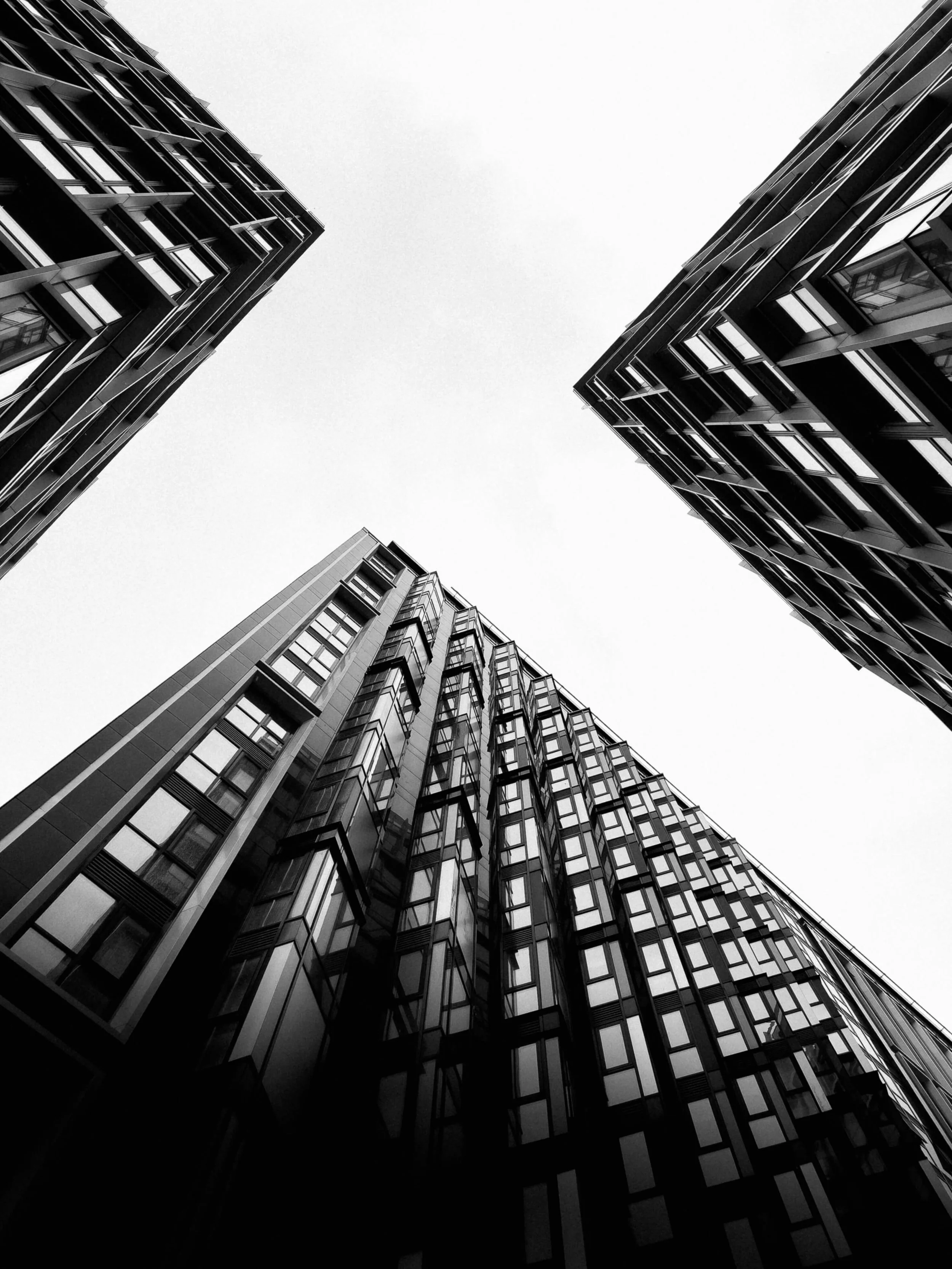 Black and White image of three high rise buildings - Mike Hindle Unsplash