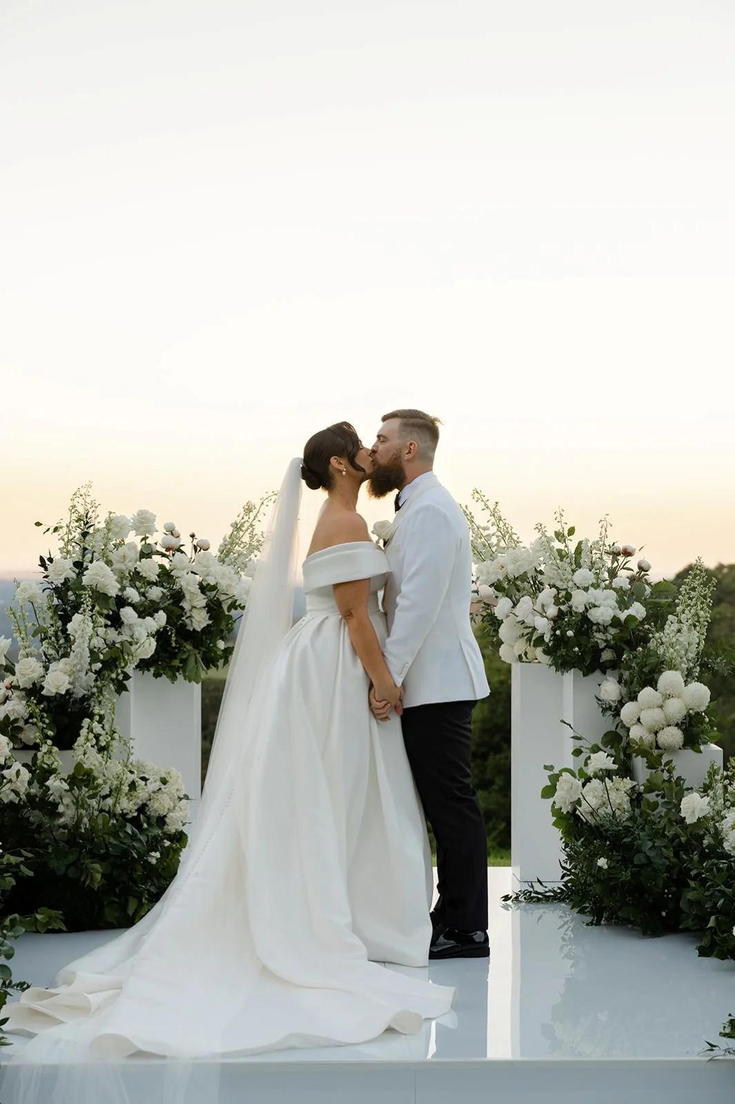 Helipad ceremony Maleny Manor with ceremony stage and white & green florals