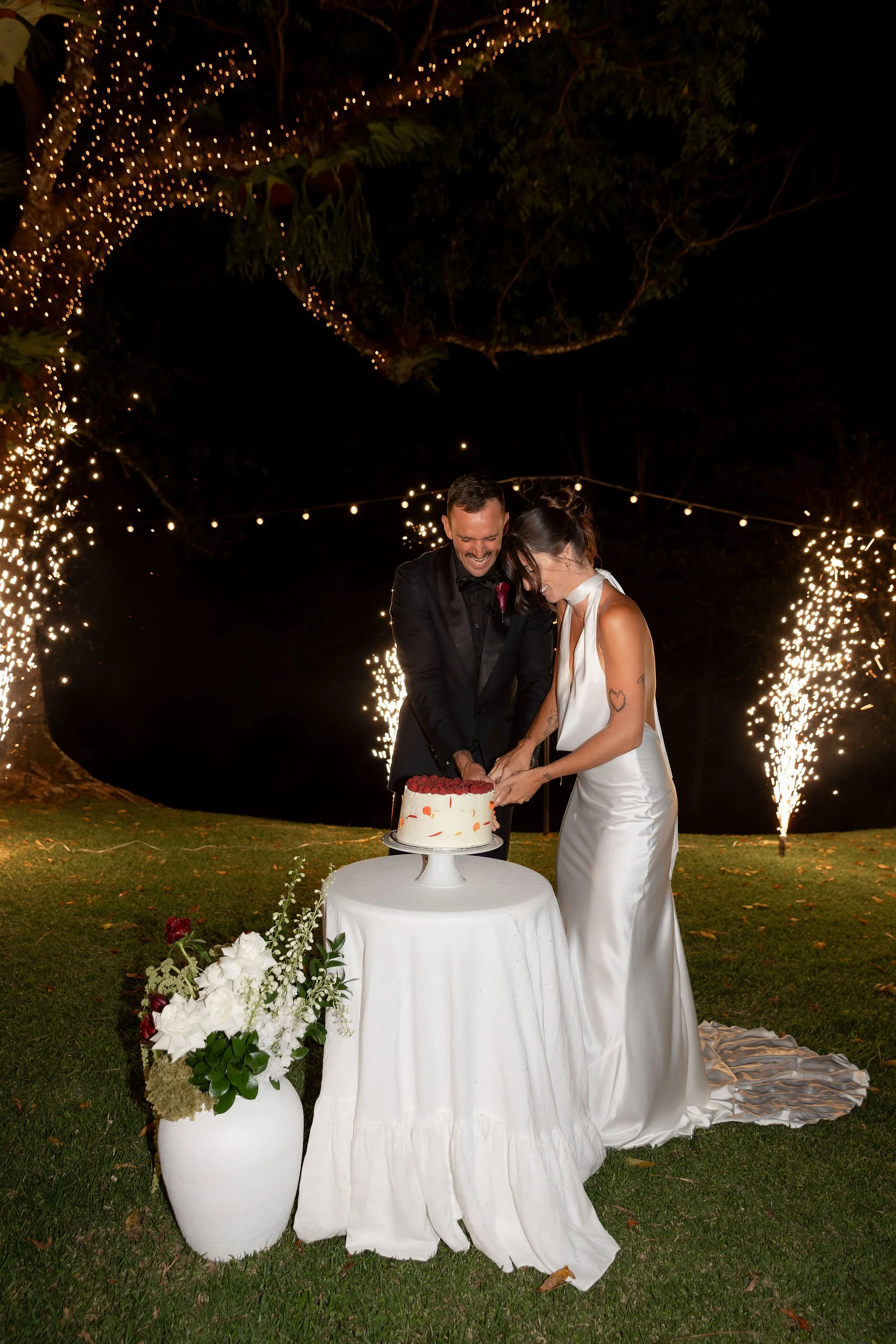 Maleny Manor Bride & Groom Cutting Cake with Fireworks and Fairylit Tree in Background