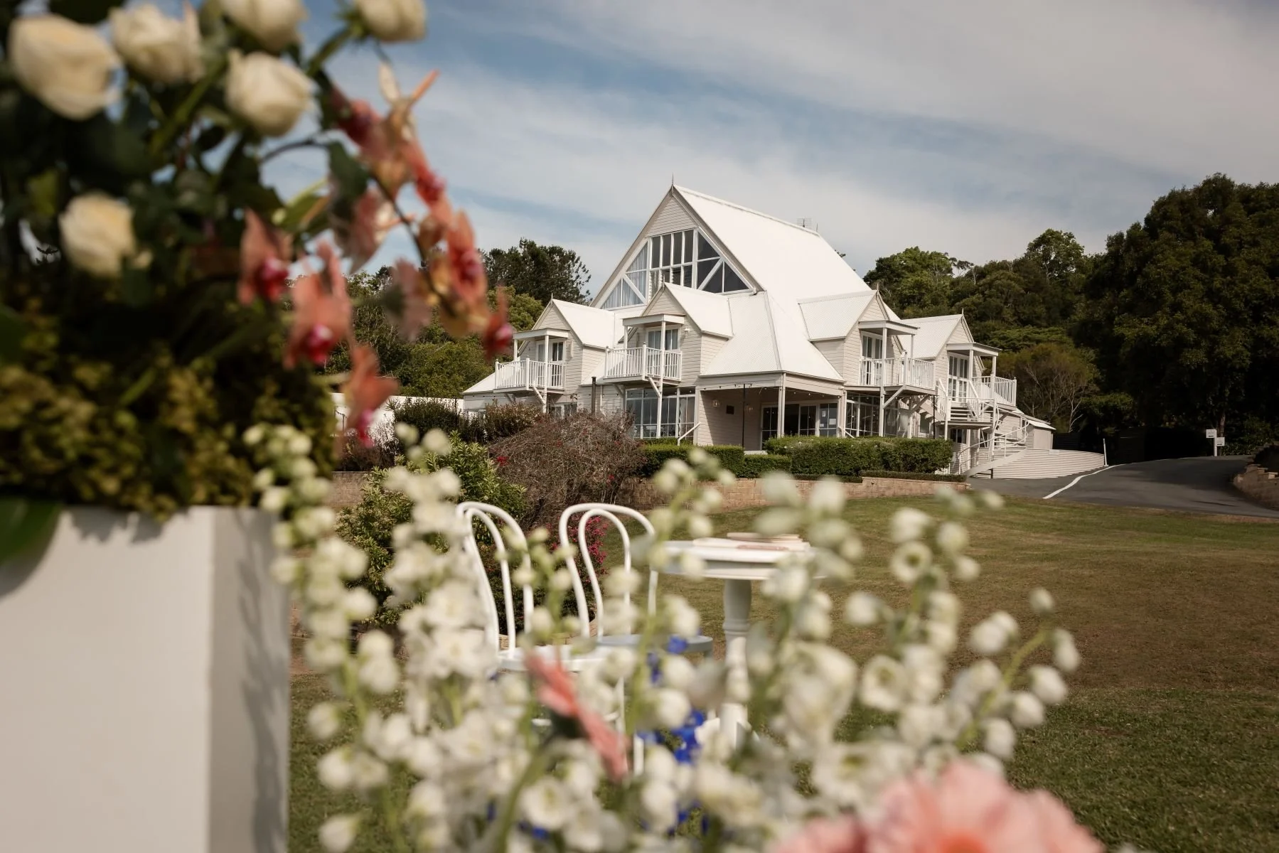 View of Maleny Manor from the Helipad Ceremony Location with gorgeous florals by Mondo Floral Designs.