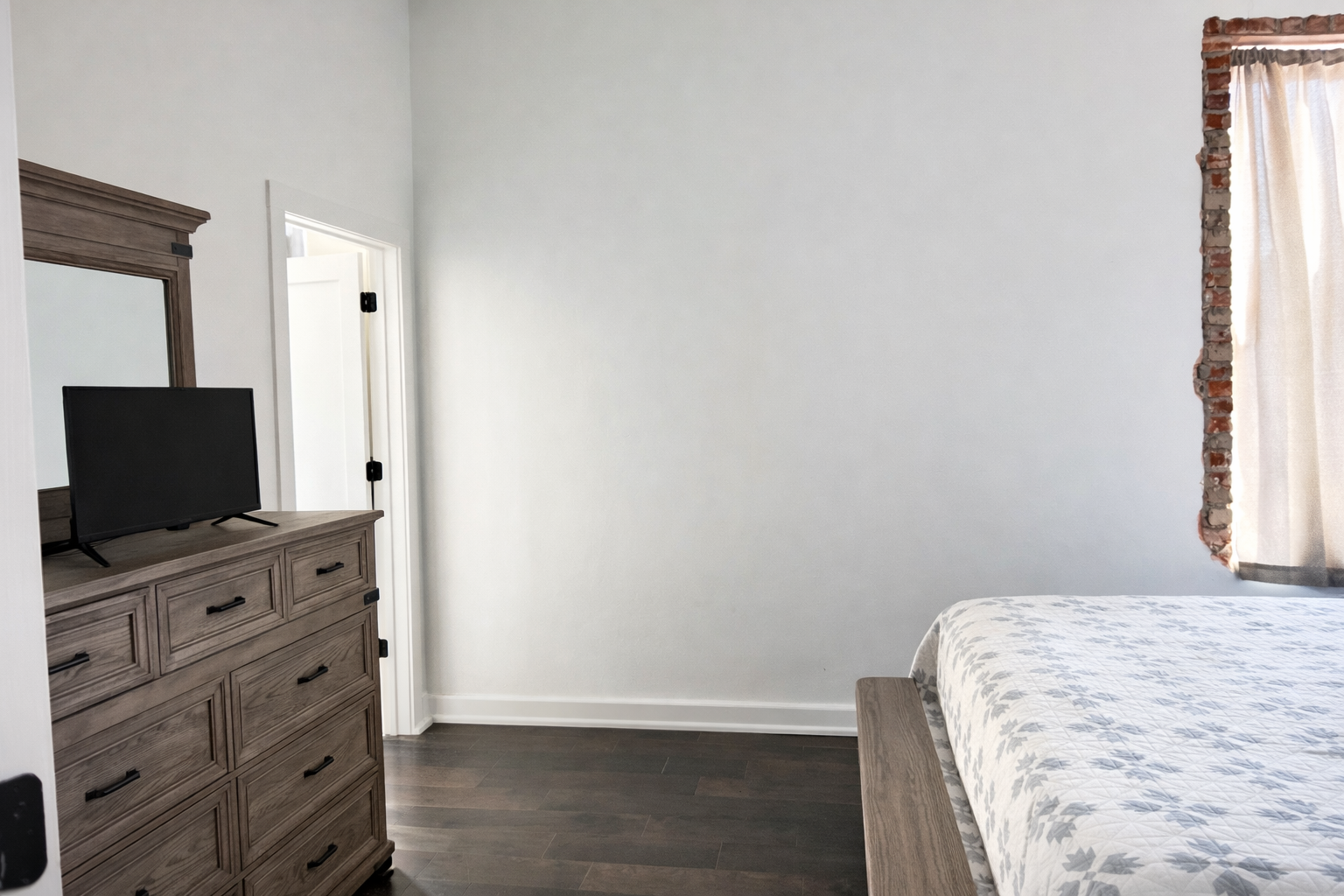 Minimalist bedroom with rustic accents.png