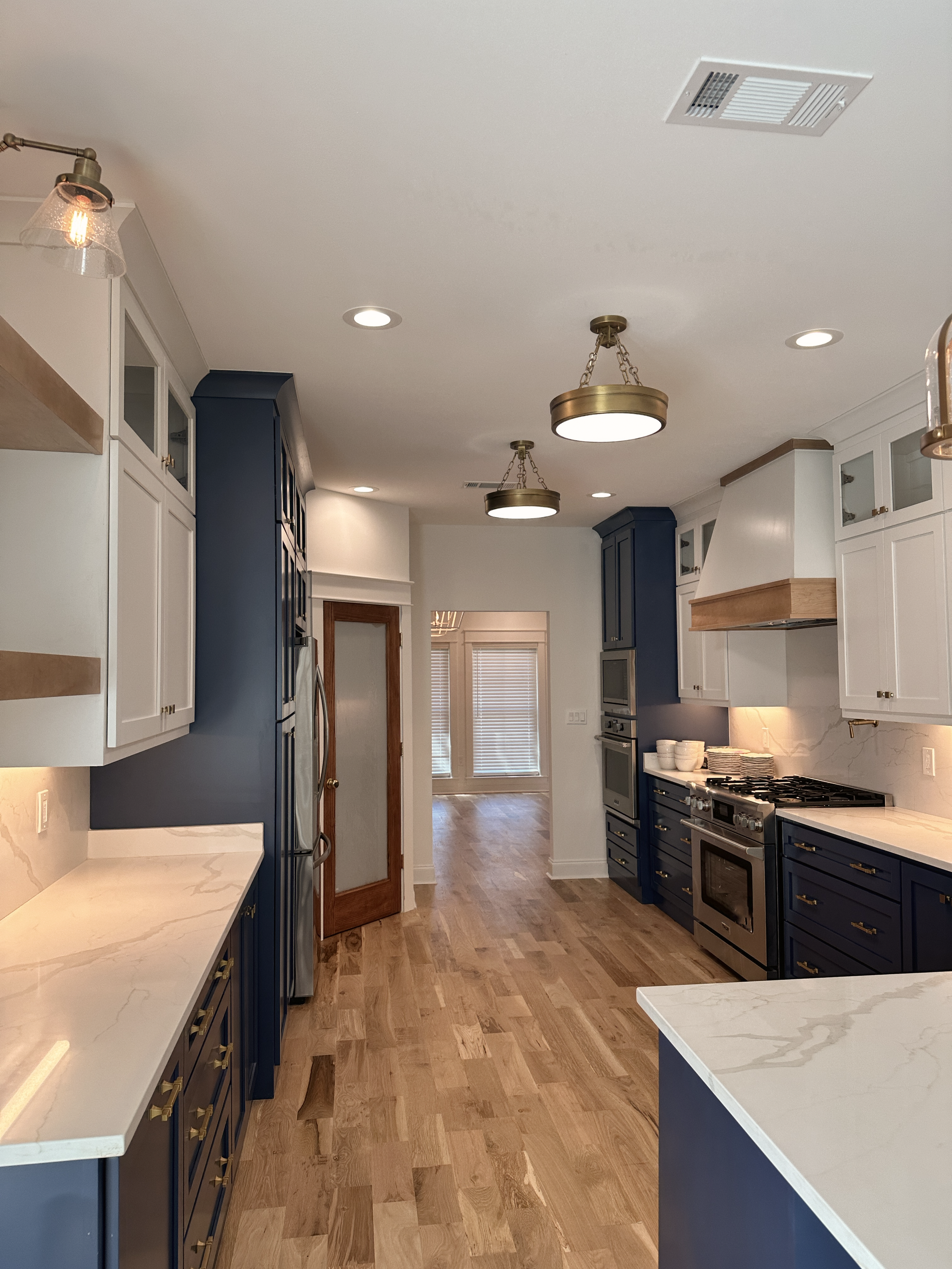 Blue and white elevated galley kitchen