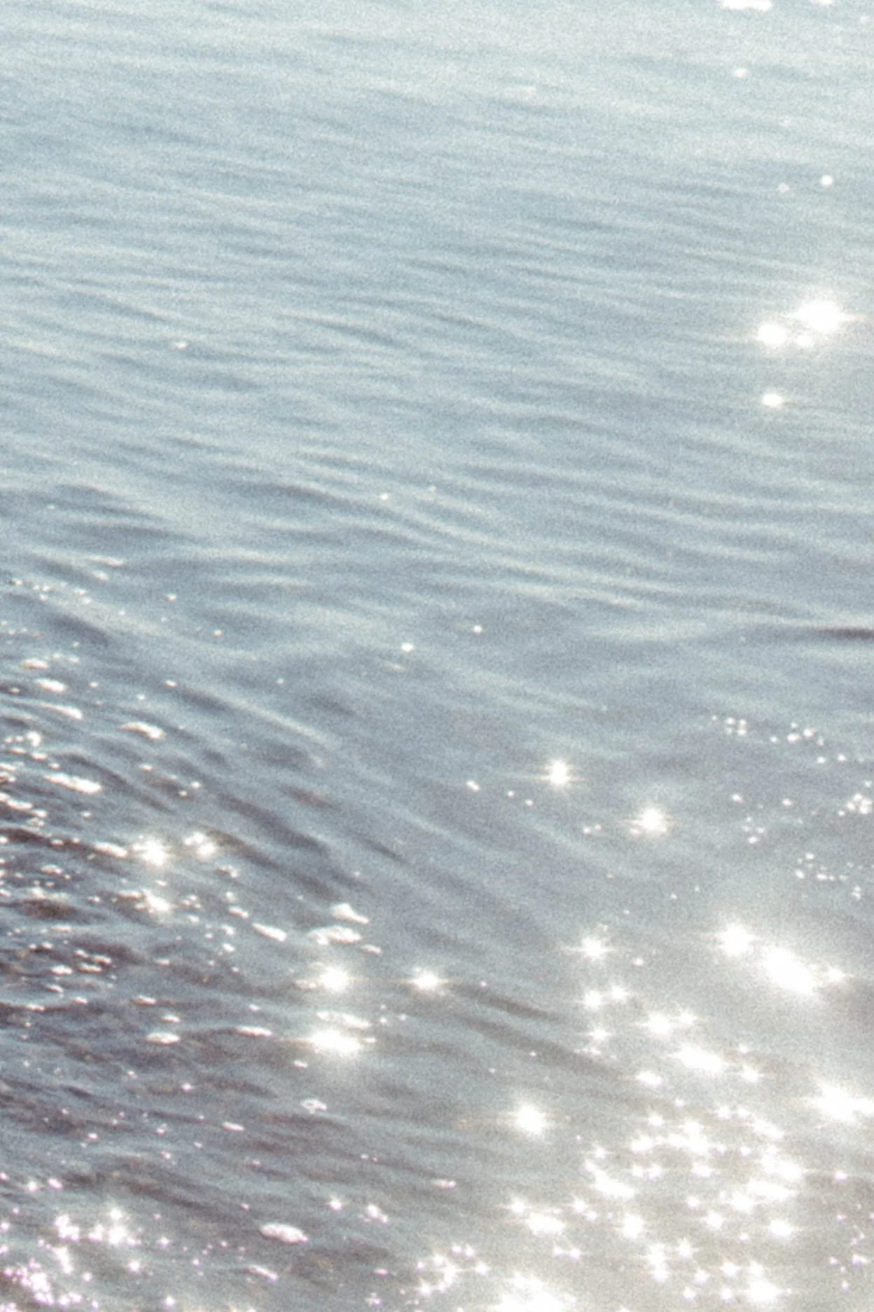 Sunlight reflecting off the surface of a calm body of water.