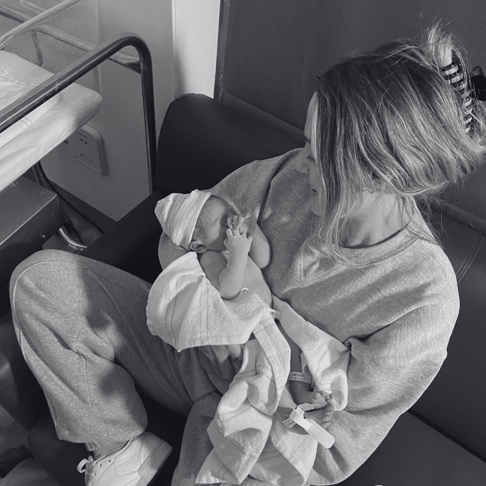 postpartum doula serving clients in hospital after birth, holding baby