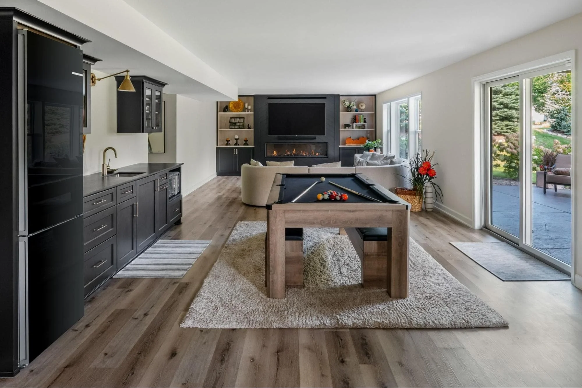 Newly remodeled basement with a pool table and new furnishings