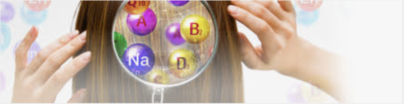 Close-up of a person holding a magnifying glass over their head, revealing colorful science-themed spheres with chemical symbols and letters, such as A, B, D, and Na.