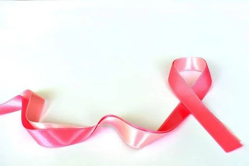 A pink satin ribbon on a white background.