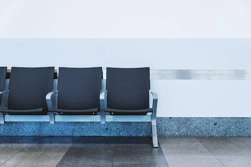 Three chairs against hallway wall