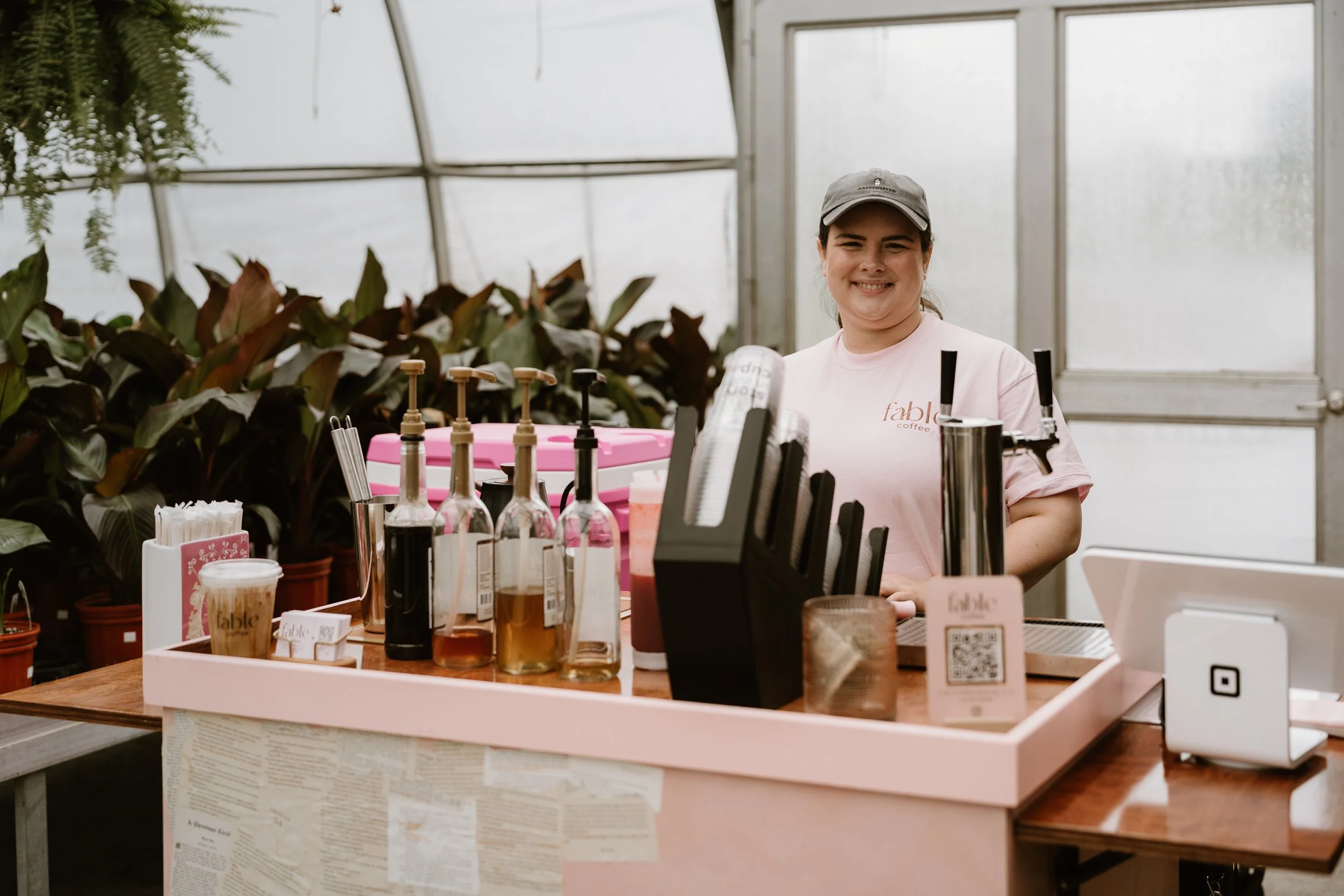 owner of fable coffee standing behind the coffee cart