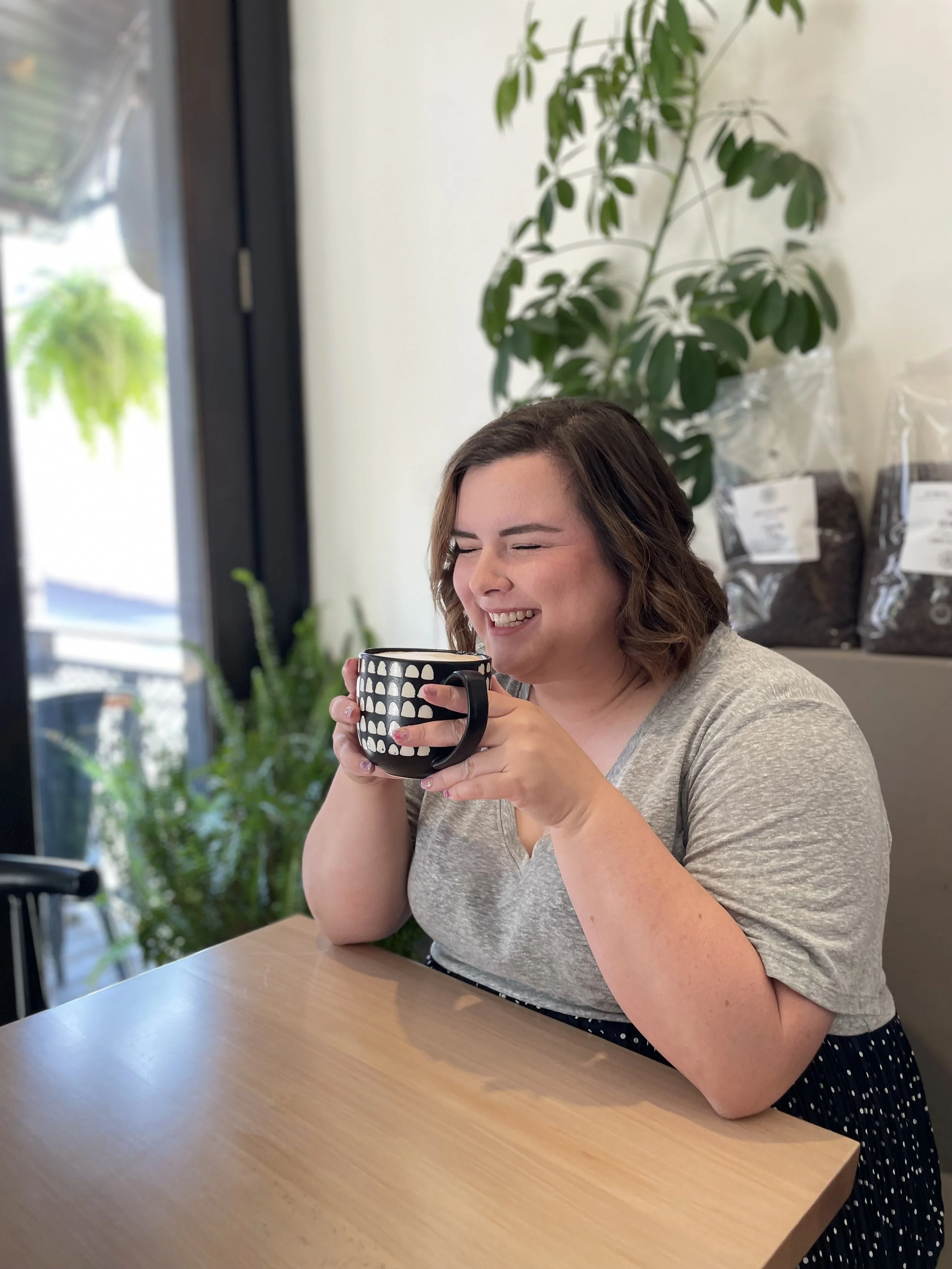 the owner of fable coffee cart drinking coffee and laughing