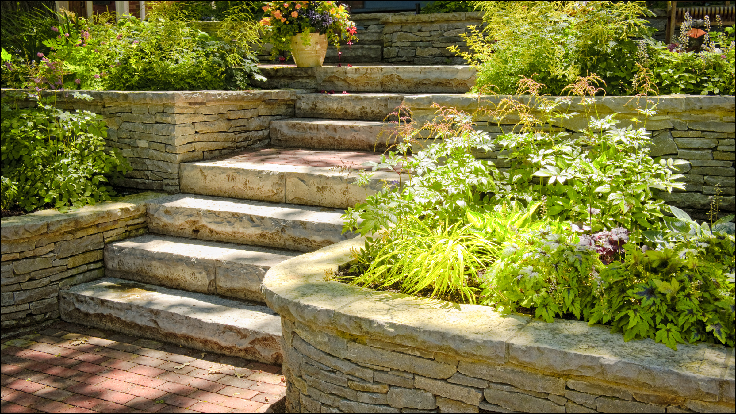 Create an outdoor haven that feels like it's part of nature with custom stone staircases and retaining walls that are both functional and visually stunning.