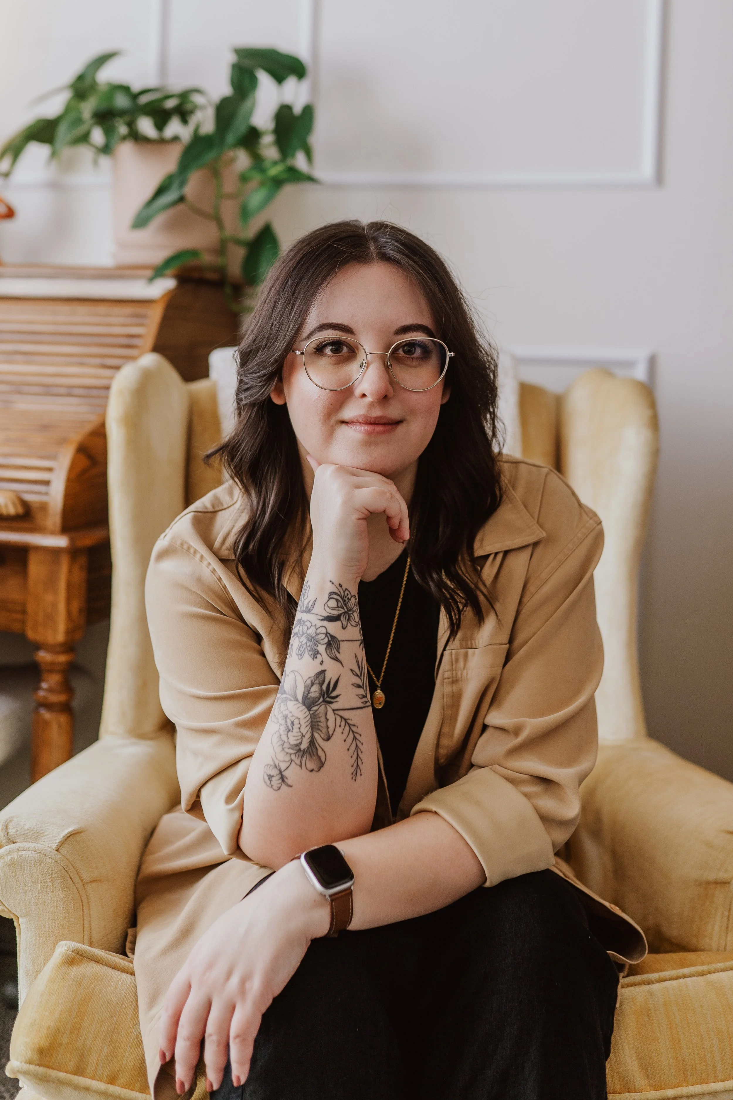 Joanna Jackson, LPC, sitting in a yellow chair, listening intently to you.