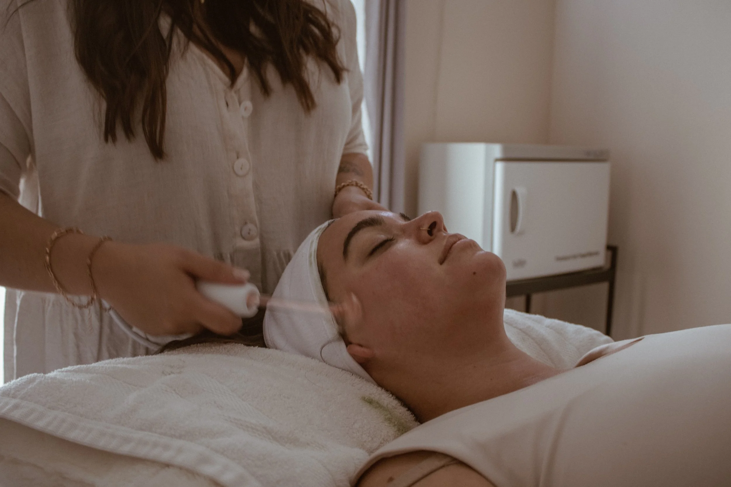 High frequency facial treatment used to calm acne and promote healing during a customized facial at Naked Skin in Vancouver, Washington.