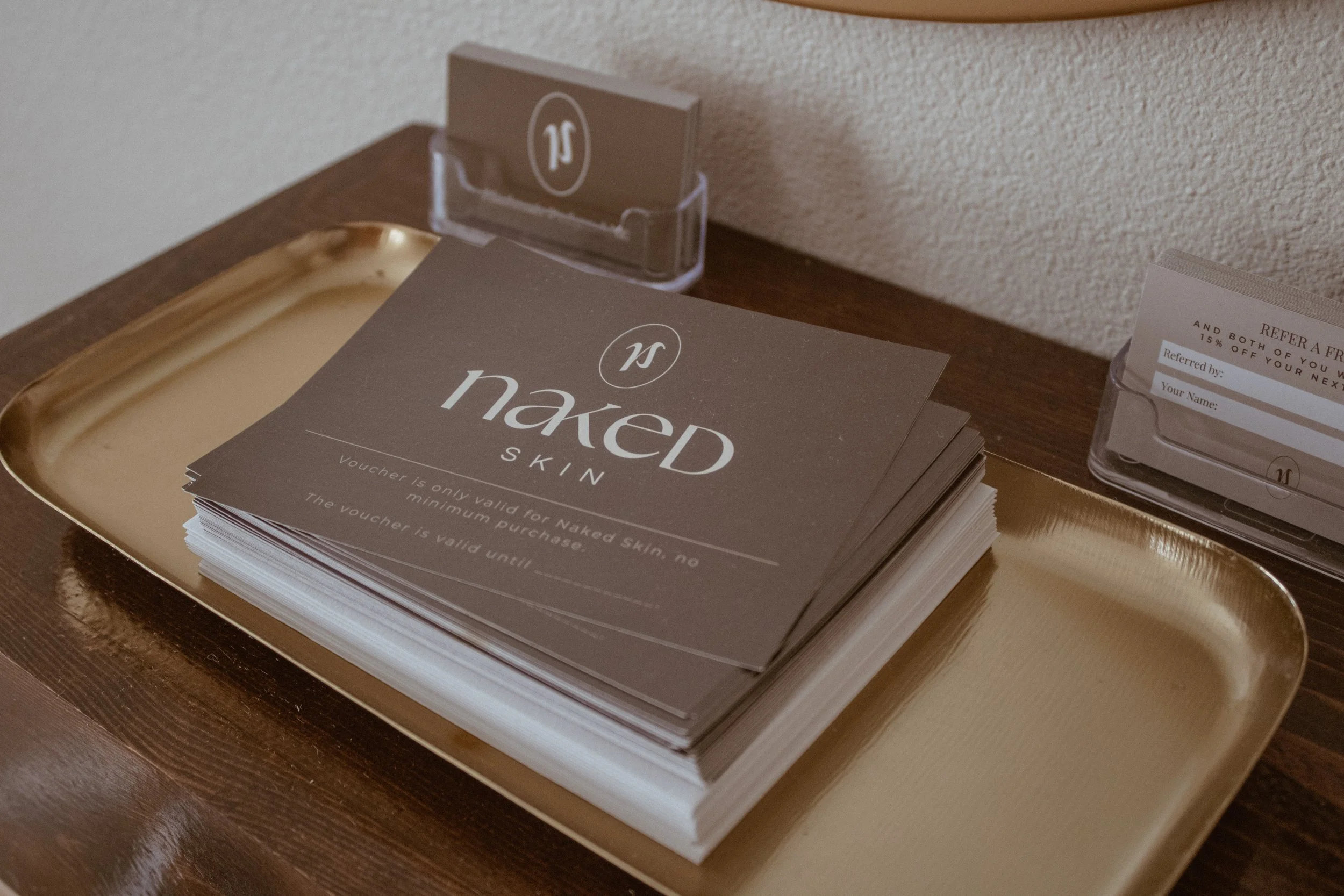 Naked Skin Esthetics appointment cards and booking materials displayed in studio in Vancouver, Washington