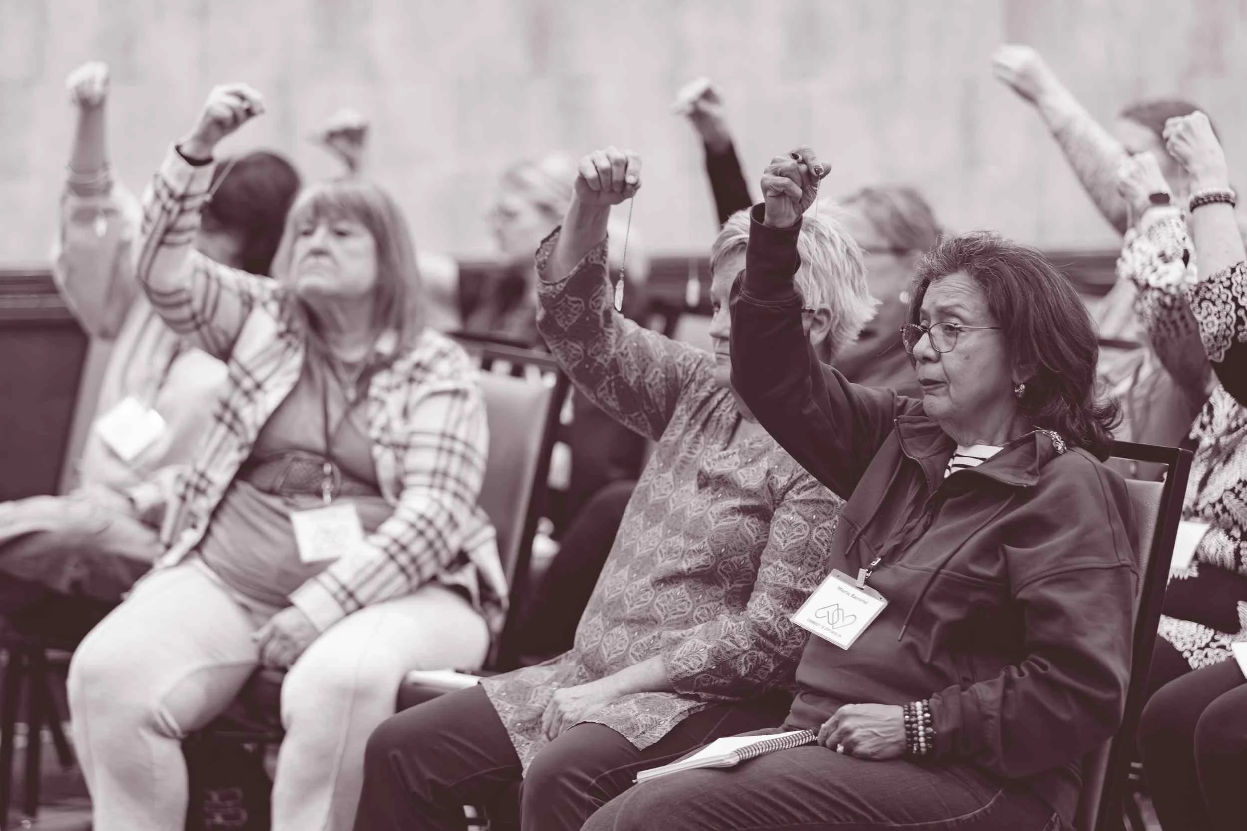  Conference participants engaging in an interactive workshop activity during a live spiritual event 
