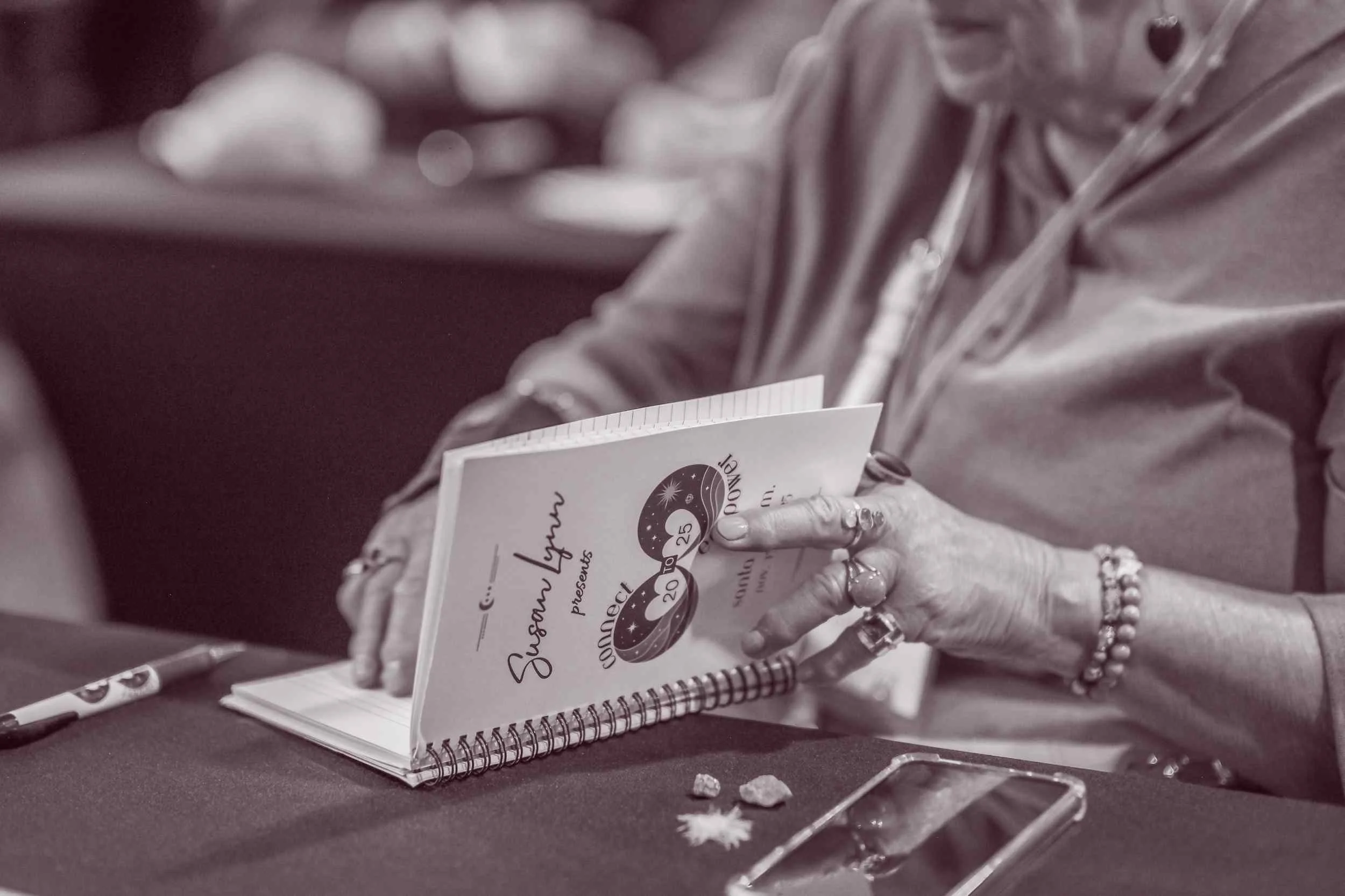  Close-up of workshop materials and note-taking during a Connect to Empower spiritual learning session 