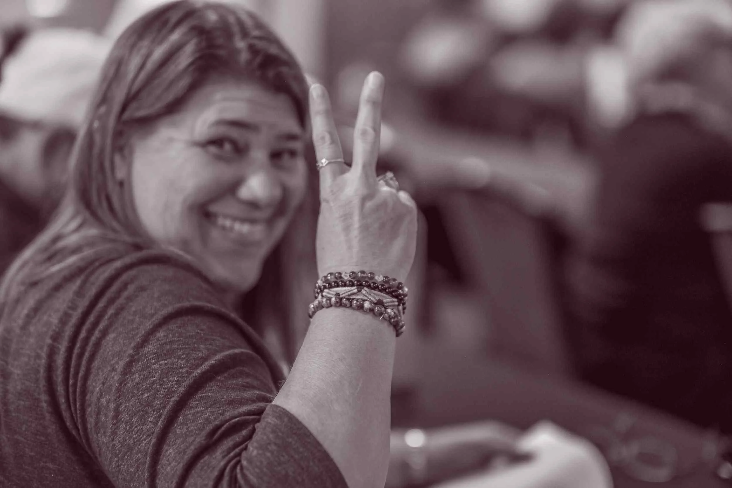  Attendee smiling during a live spiritual conference and community gathering with Susan Lynn 